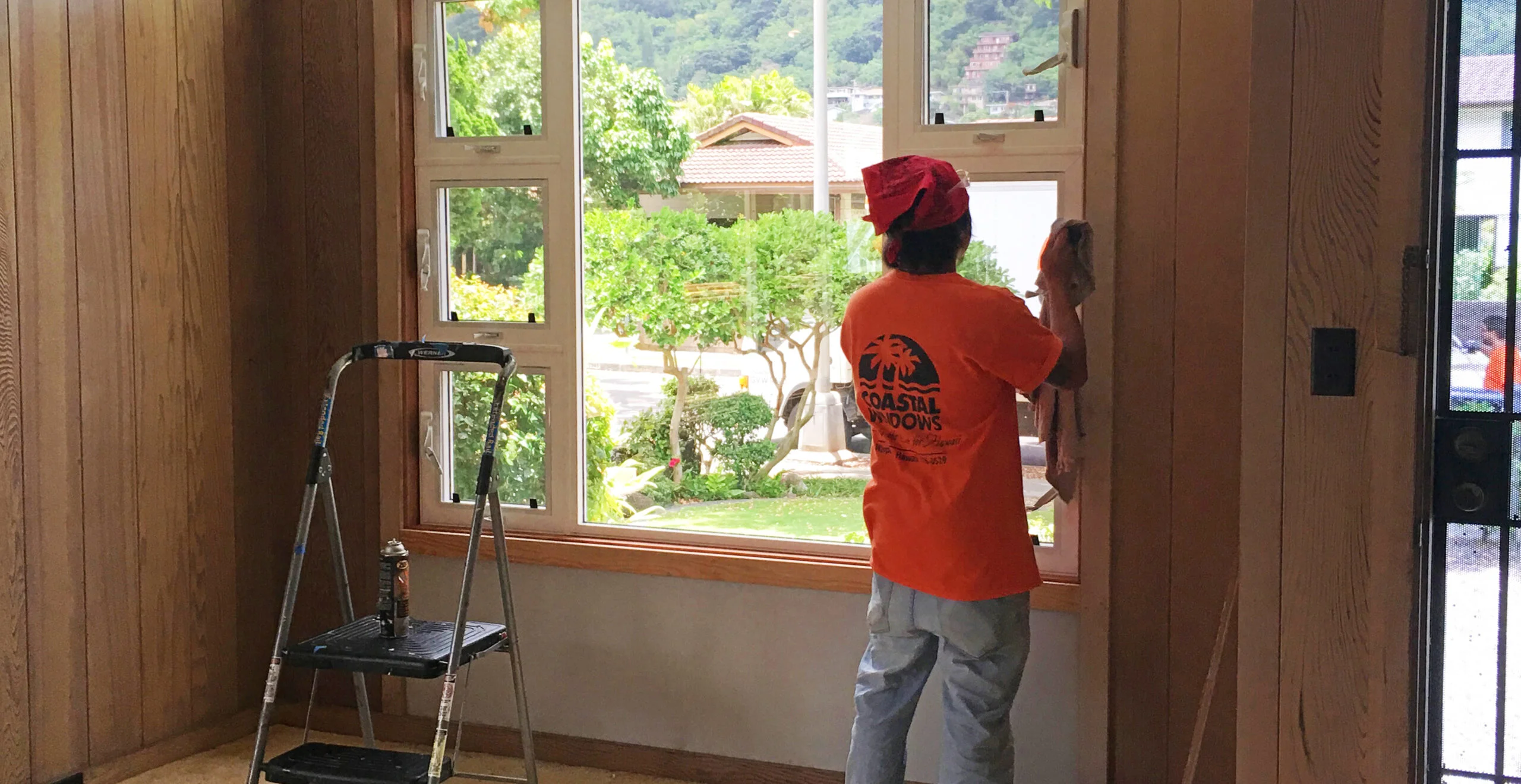 Coastal Windows installer finishing a window installation