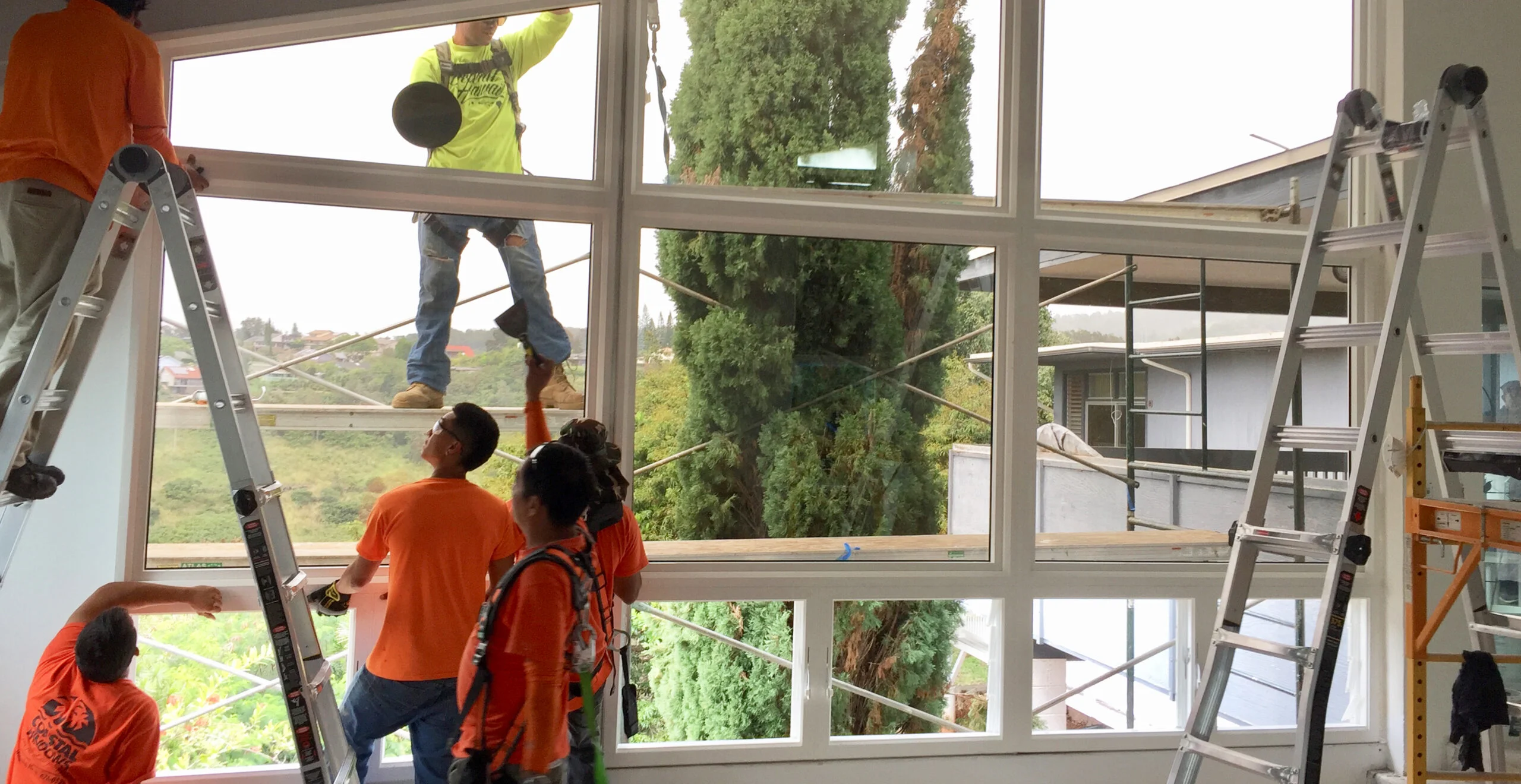 Coastal Windows installer fitting a window